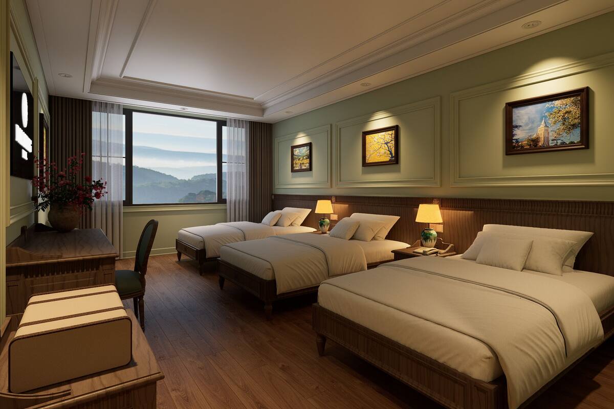 A hotel room with two beds, a desk, and a chair.