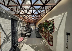 A gym with exercise equipment, a treadmill, and a wall-mounted plant.