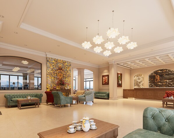 A spacious lobby with a high ceiling, elegant furniture, and a large window offering a view.