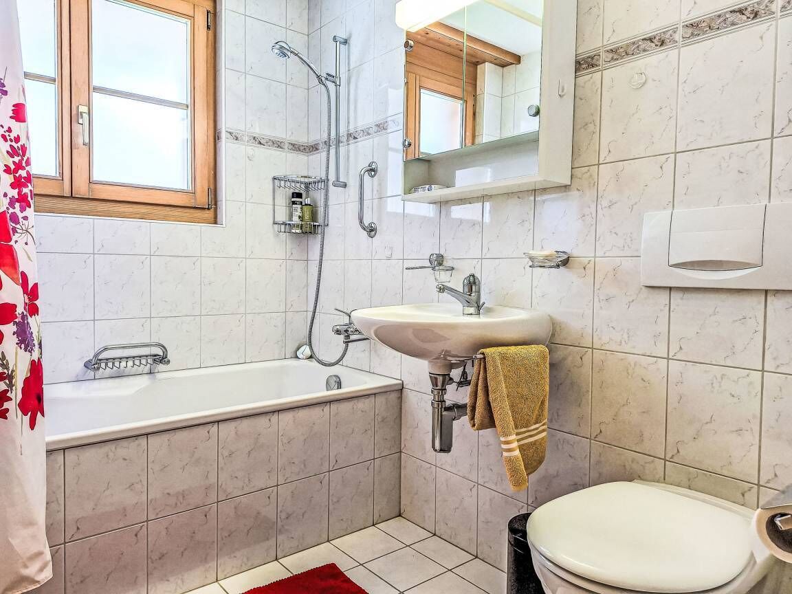 A bathroom with a bathtub, sink, and toilet.