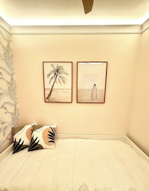 A bedroom with a bed, two framed pictures on the wall, and patterned curtains. - Casa Mar - Beautiful apartment with an ocean view on Matosinhos Beach in Porto (Matosinhos)