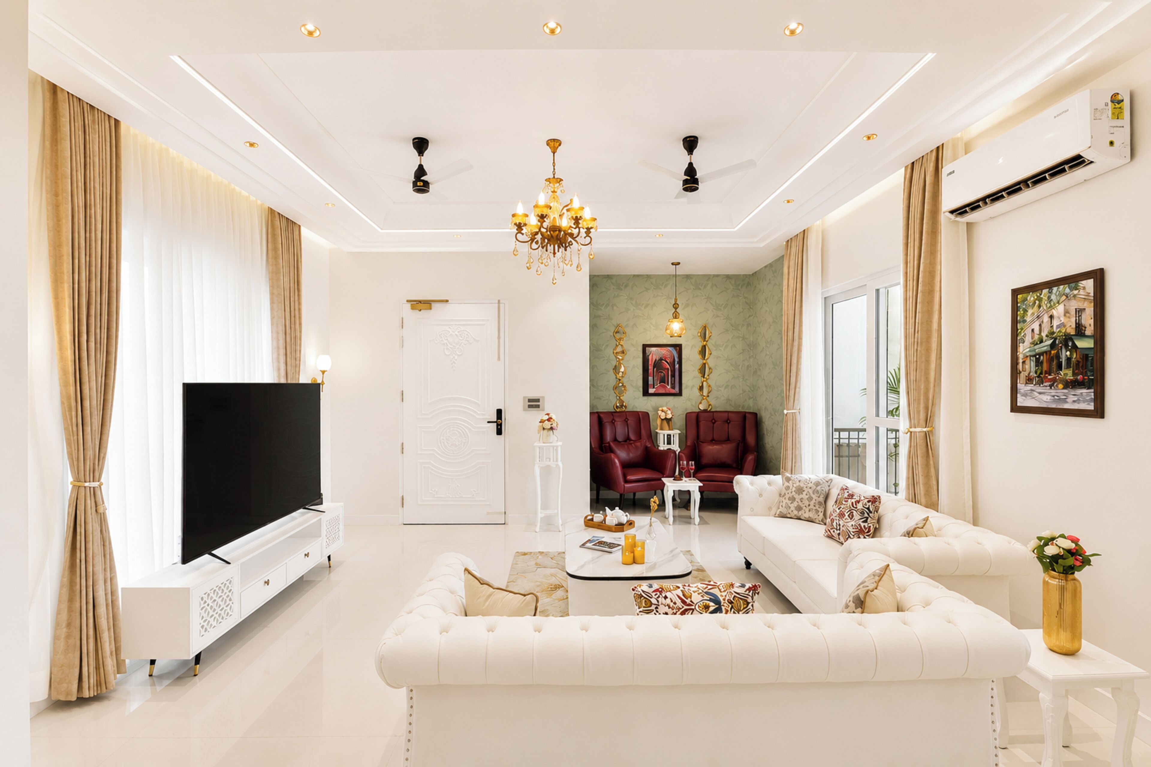 A modern living room with a flat-screen TV, a white sofa, a coffee table, and a chandelier.