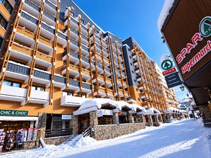 Um hotel com vários andares, varandas, uma fachada visível com o nome 'CHIC & CHOC' e um letreiro da 'SPAR'.