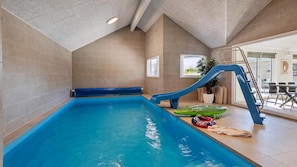 An indoor swimming pool with a slide, a sunroof, and a view of the outside. - VillaVilla 962 - Marielyst, Lolland/Falster/møn (Idestrup)