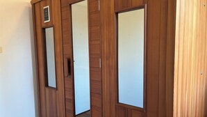 A wooden wardrobe with mirrored doors and a small shelf. - House for 8 people in Meymac with electric bikes (Meymac)