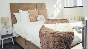 A bedroom with a bed, nightstands, a lamp, and a window. - Queensferry Collection - Residence 7 (Derby)