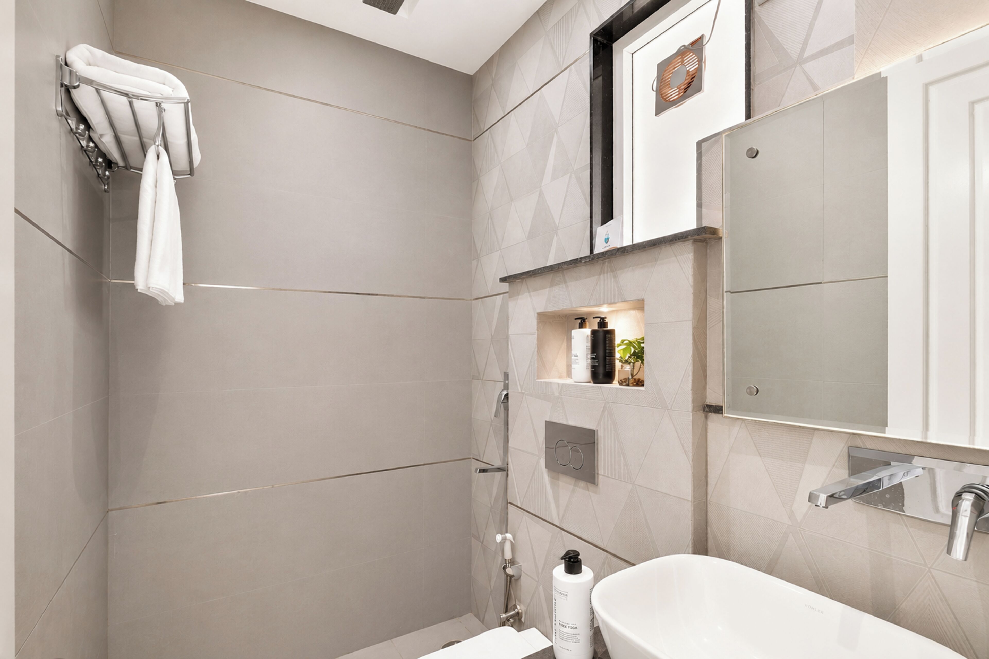 A modern bathroom with a shower, a sink, and a mirror.
