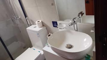Shower, hair dryer, slippers, towels