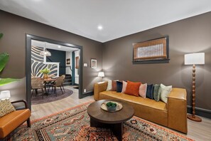 A modern living room with a sofa, coffee table, and patterned rug. - Welcome to Sue Zen Urban Retreat — Grandview Heights, Columbus (Grandview Heights)