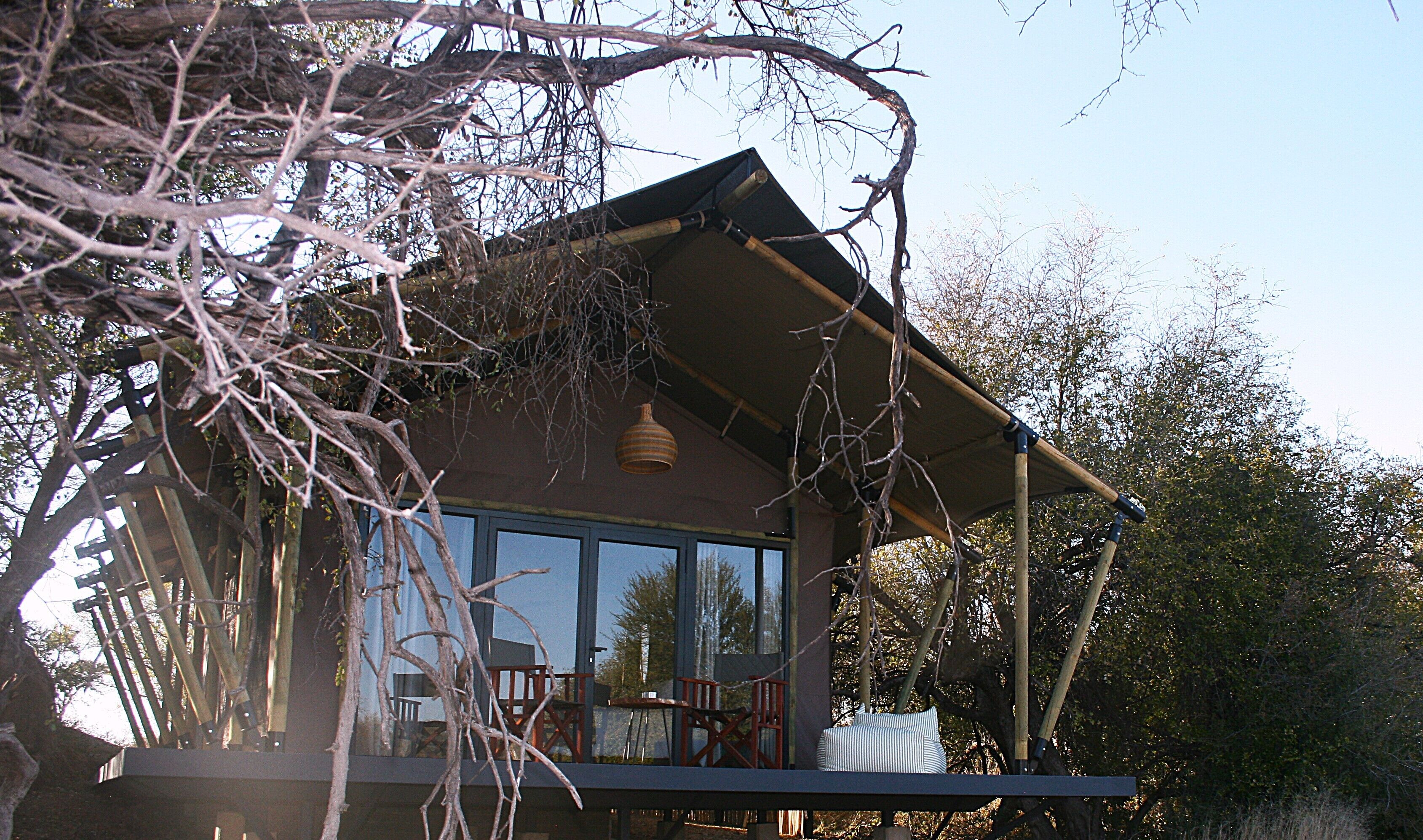 A house with a large window, a balcony, and a hanging light fixture.