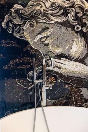 A mosaic artwork with a faucet and showerhead. - Voko by Uka Boutique Hotel (Tirana)