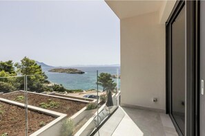 A balcony with a view of the sea and a distant island. - Villa Luce Pelješac (Potomje)
