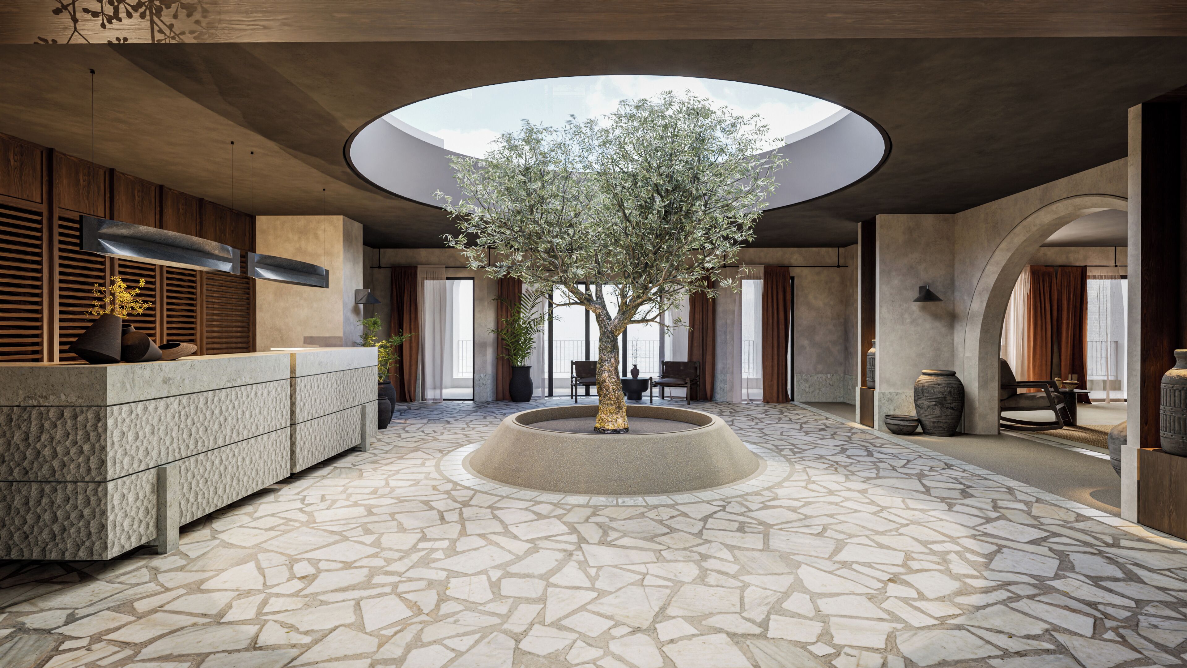 Un vestíbulo amplio con un árbol central, un mostrador de recepción y un tragaluz circular.