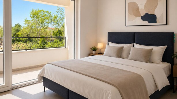 A bedroom with a bed, a nightstand, a lamp, a window with a view of greenery, and a wall-mounted abstract painting. - Amazing home in Privlaka (Privlaka)