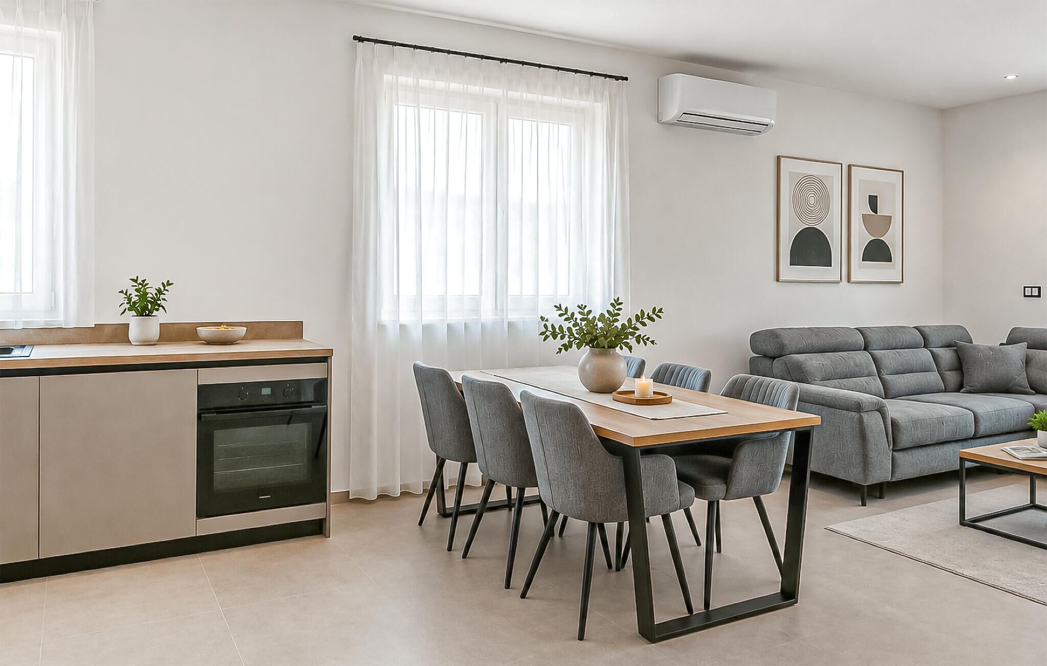 A modern living space with a kitchen, dining area, and seating area.