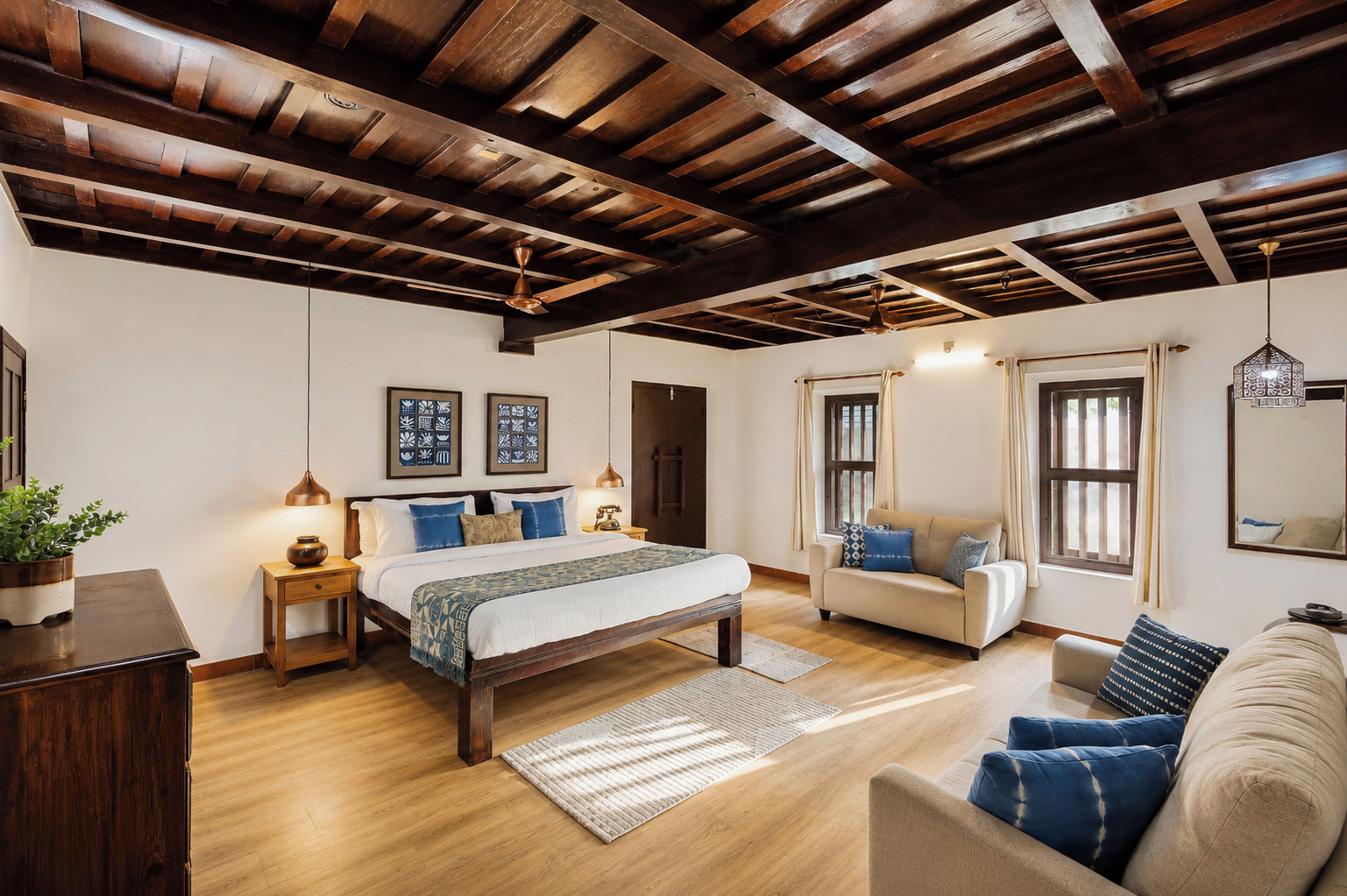 Un dormitorio con techo de madera, una cama con colcha estampada, un sofá y una ventana con cortinas.