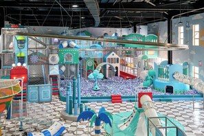A children's play area with various play structures, a ball pit, and a slide. - Arda Turan (Khiva)