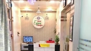 A reception area with a desk, chairs, a TV, and a sign reading 'Hotel Epin.' - Hotel Epar Bangla (Agartala)