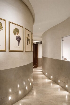 A curved hallway with a polished floor and recessed lighting.