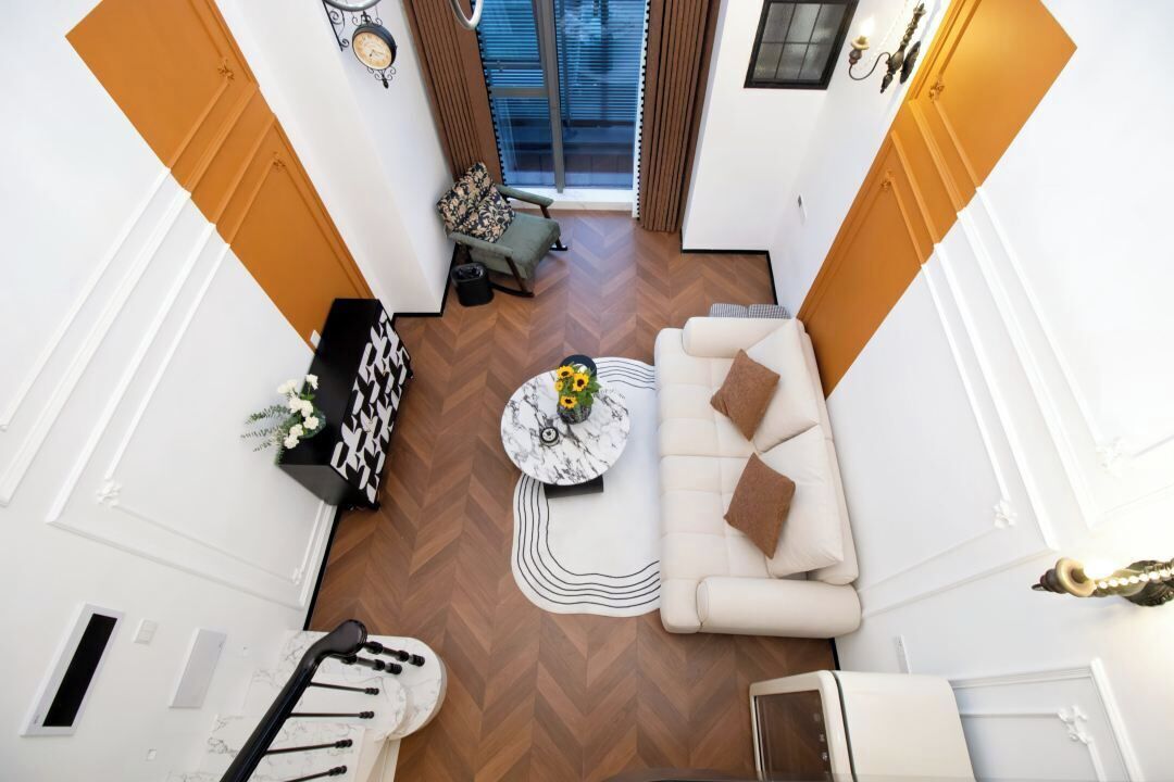 A modern living room with a sofa, coffee table, and decorative items.