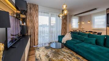 Apartment (Two Bedroom Apartment) | Living room | 32-inch flat-screen TV with satellite channels