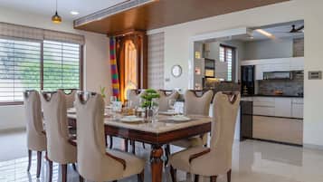 A dining area with a large wooden table, six chairs, and a decorative centerpiece.