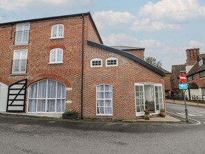 A brick building with a garage door, large windows, and a one-way street sign. - 2 Bed (Southampton)