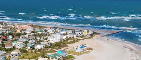 A coastal residential area with houses near the beach.
