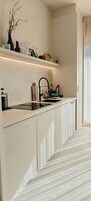 A modern kitchen with a built-in stove, a sink, and a countertop.