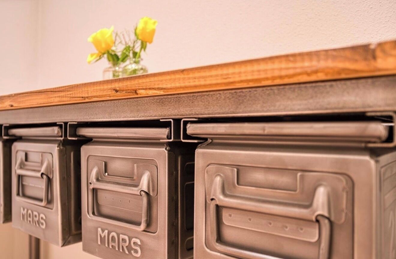 A set of storage boxes labeled 'MARS' on a wooden surface.
