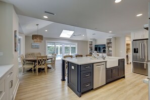 A modern kitchen with a central island, built-in appliances, and a dining area with natural light. - 3 Jessamine - A Coastal Comfort Escape Available Starting August 2026! (Hilton Head Island)