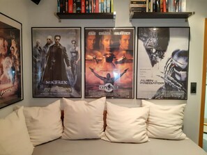 A room with a bed, pillows, and three movie posters on the wall. - Apartment 'Otto' in Nürnberg (Nuremberg)