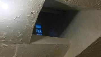 A room with a sloped ceiling and a small window.