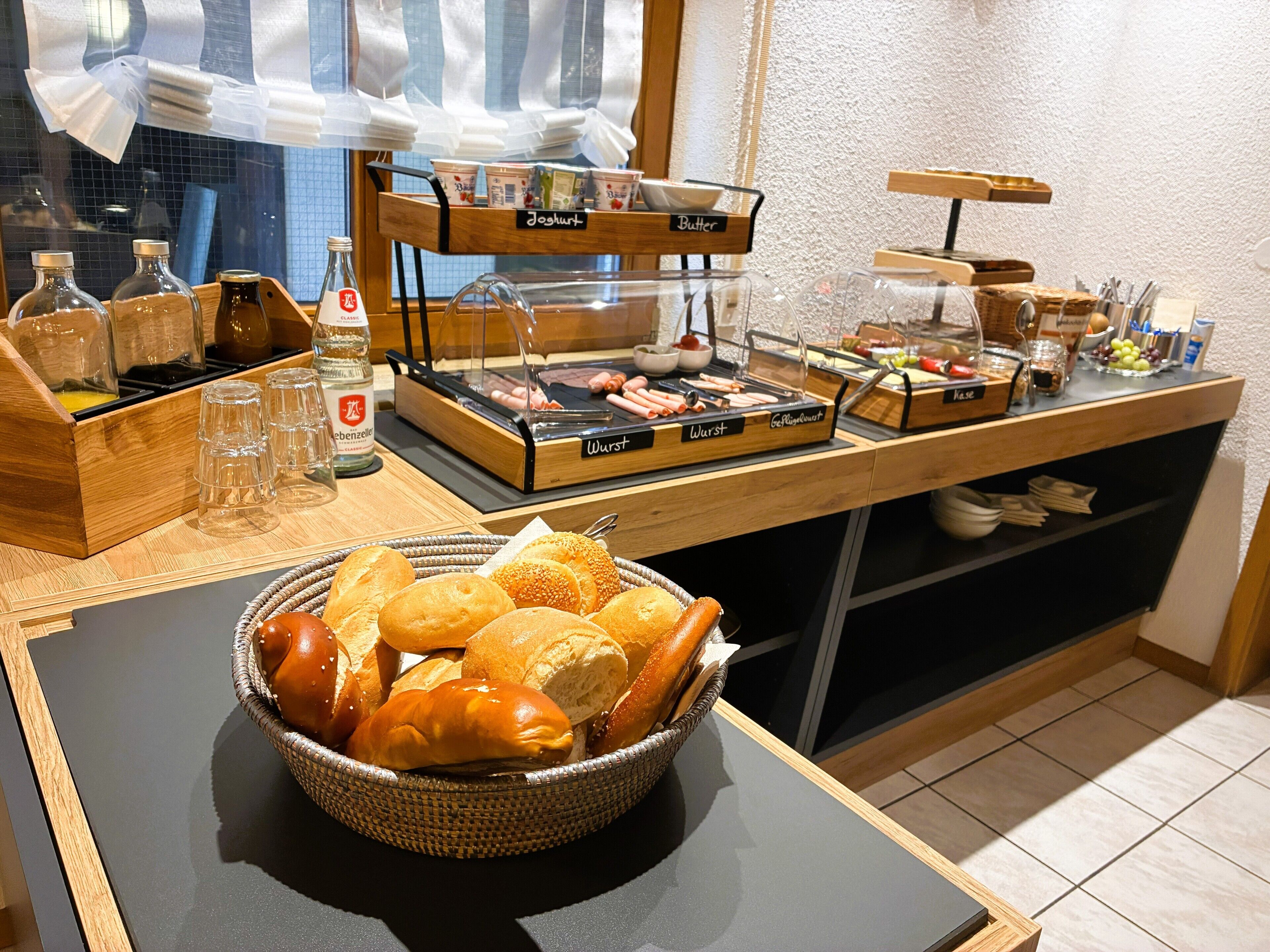 A buffet setup with various food items and condiments.