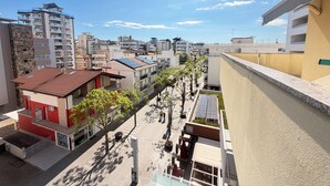 A residential area with modern buildings, solar panels, and a clear sky. - Stunning penthouse with a sun terrace in the center of Lignano, 150 meters from the sea (Lignano Sabbiadoro)