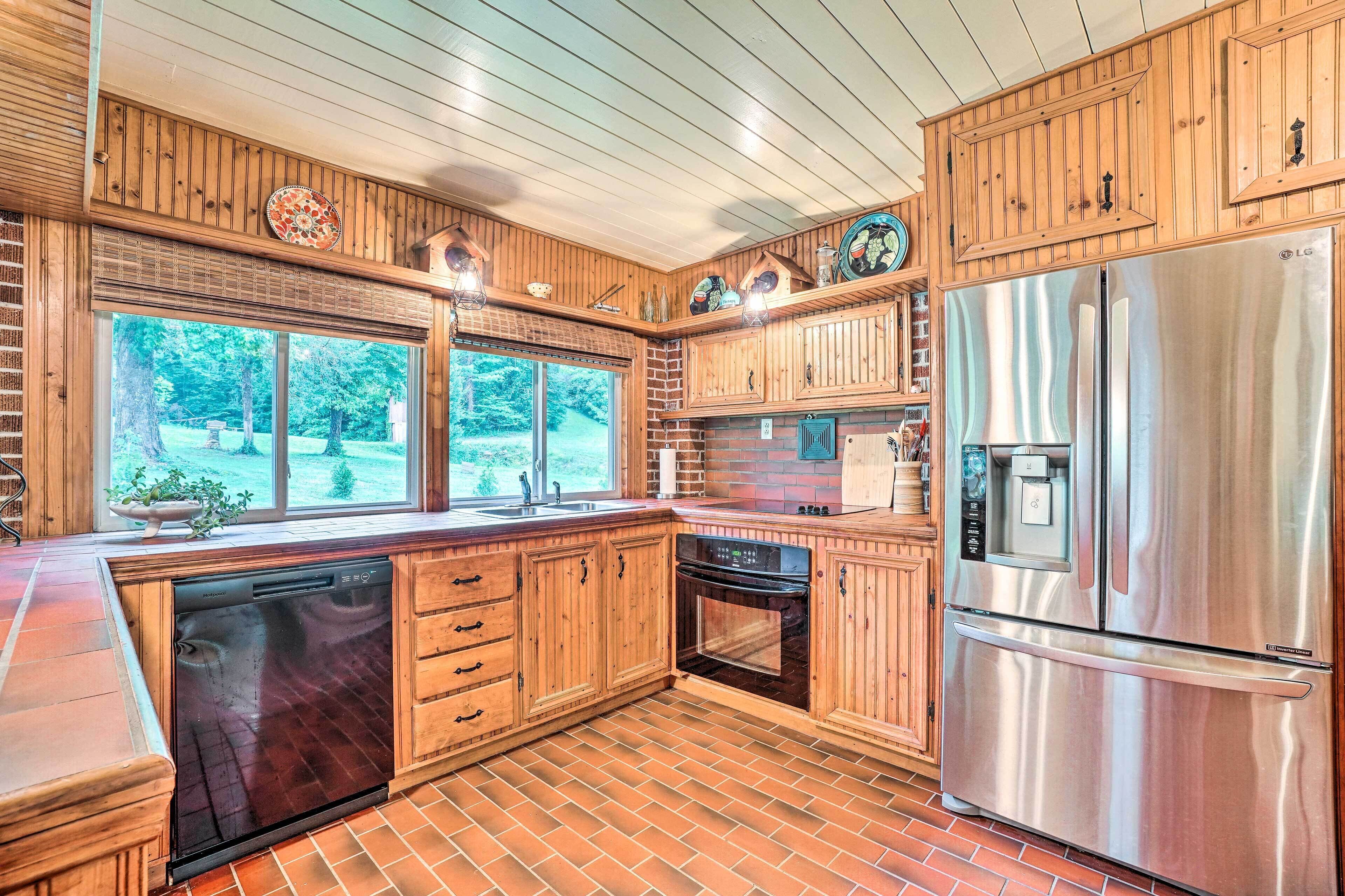 A kitchen with wooden cabinets, a stainless steel refrigerator, and a dishwasher.