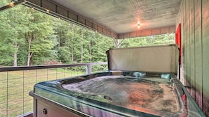 A hot tub in a covered outdoor area with a view of a forest. - 2-home Country Estate Near Clayton! 2 Hot Tubs (Clayton)