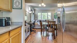 A kitchen with a refrigerator, coffee maker, and wooden cabinets. - Half Block to Train! South Beacon Hill Area Home (Seattle)