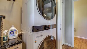 A front-loading washer and dryer with a control panel, a bottle of All Free Clear detergent, and a Magic Chef appliance on a countertop. - Half Block to Train! South Beacon Hill Area Home (Seattle)