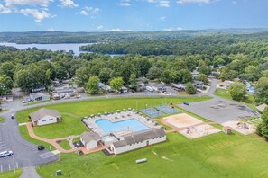 An aerial view of a residential area with a swimming pool, a parking lot, and a playground. - Pool & Dock Access! Badin Lake Resort Gem (New London)