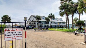 A gated entrance to a private residential area with a sign indicating it is for owners and guests only. - 3BR Condo on the Bay w/ Pool and Perks (Rockport)