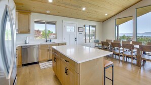 A modern kitchen with wooden cabinets, a stainless steel refrigerator, and a large island. - 2 Mi to Bear Lake! Group Getaway w/ Mountain Views (Garden City)