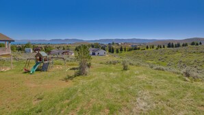 A residential area with a playground, houses, and a clear view of distant mountains. - 2 Mi to Bear Lake! Group Getaway w/ Mountain Views (Garden City)