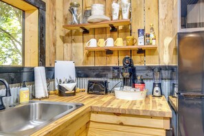 A kitchen with wooden shelves, a sink, a toaster, and a blender. - Creek Access & On-site Trails: Serene Ozark Cabin (Stella)