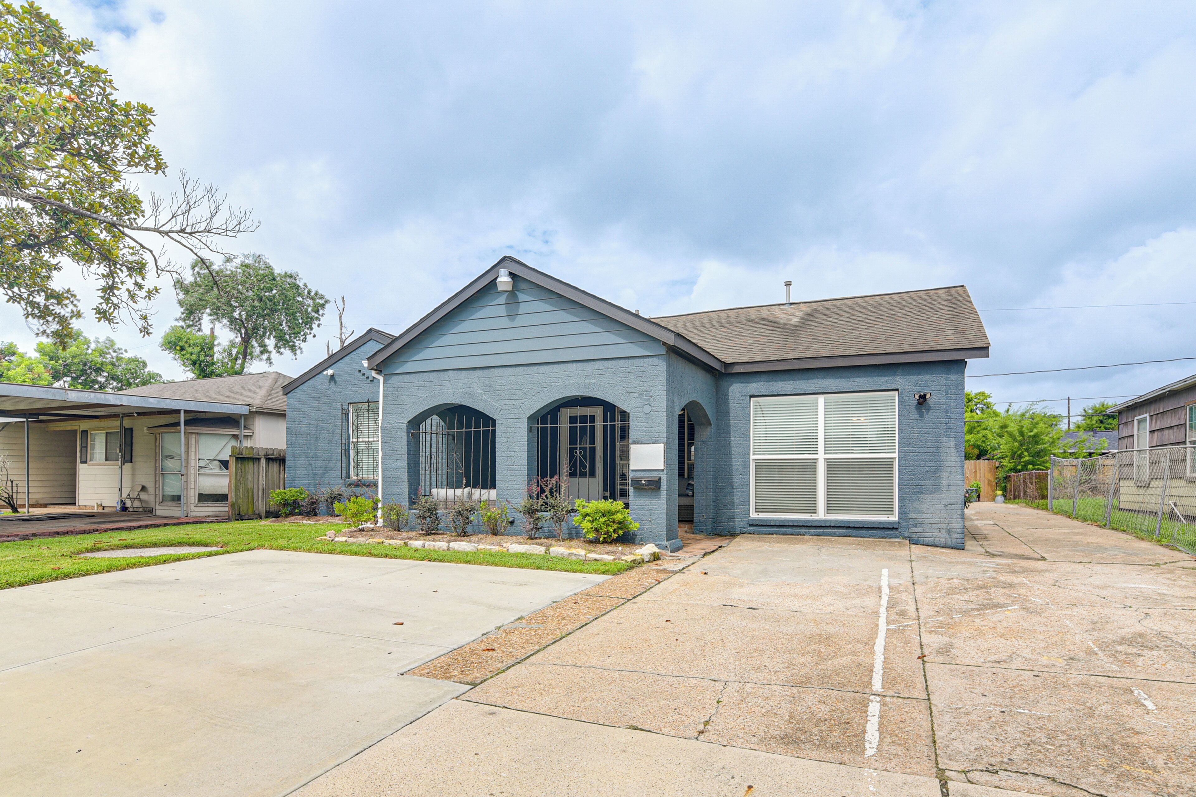 A residential house with a garage, a front yard, and a driveway.