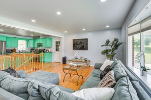 A spacious living area with a sofa, a coffee table, and a view of the kitchen. - 5 Mi to Dtwn Harrisburg! Retreat w/ Spacious Yard (Harrisburg)