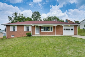 A single-story brick house with a red roof, a garage, and a well-maintained lawn. - 5 Mi to Dtwn Harrisburg! Retreat w/ Spacious Yard (Harrisburg)