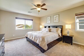 A bedroom with a bed, a ceiling fan, a window, and a nightstand with a lamp. - 12 Mi to Las Vegas Strip: Classic Home w/ Patio! (Las Vegas)