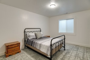 A bedroom with a single bed, a nightstand, a dresser, and a window with blinds. - 6 Mi to Dtwn! Idaho Falls Escape w/ Private Yard (Idaho Falls)