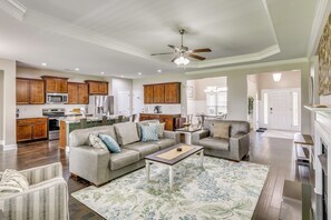 A spacious living room with a sofa, coffee table, and a patterned rug. - Spacious Meridianville Family Home w/ Patio (Meridianville)
